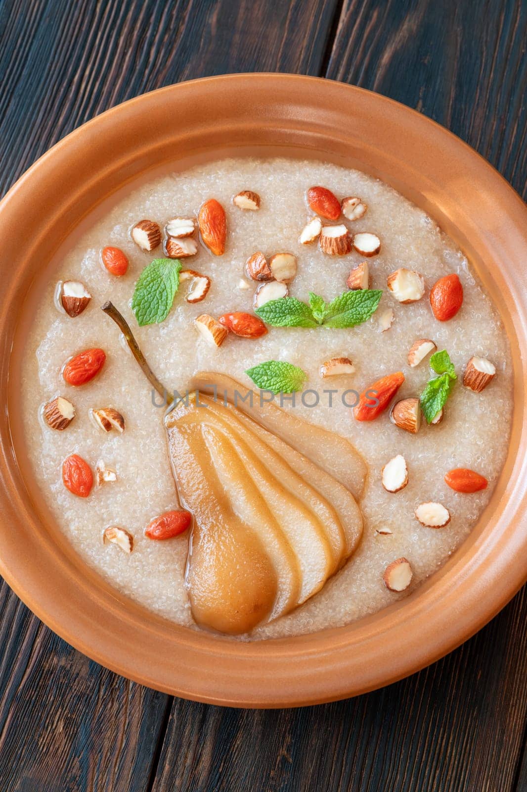 Amaranth Porridge with poached pear, almond and goji