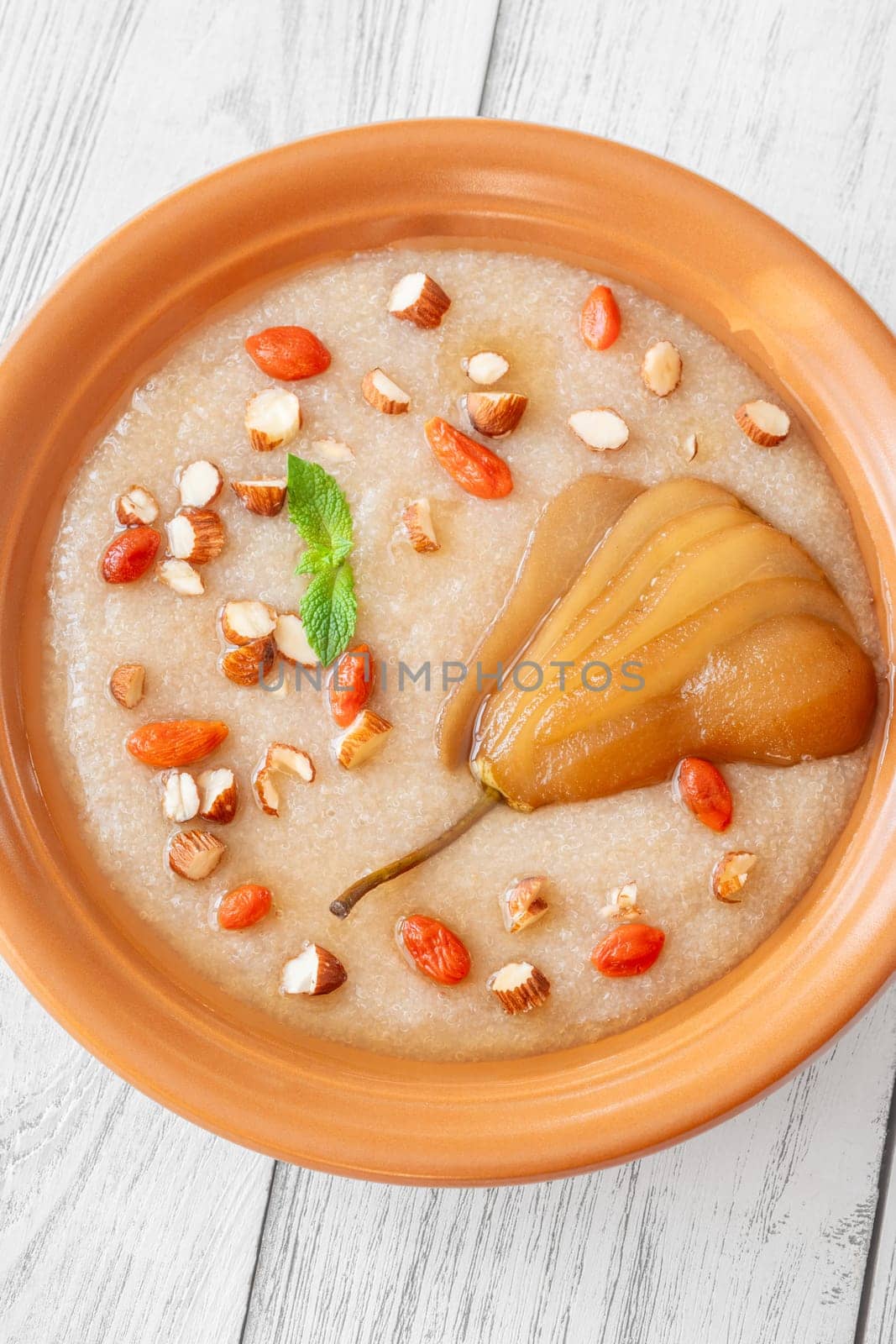 Amaranth Porridge with poached pear, almond and goji