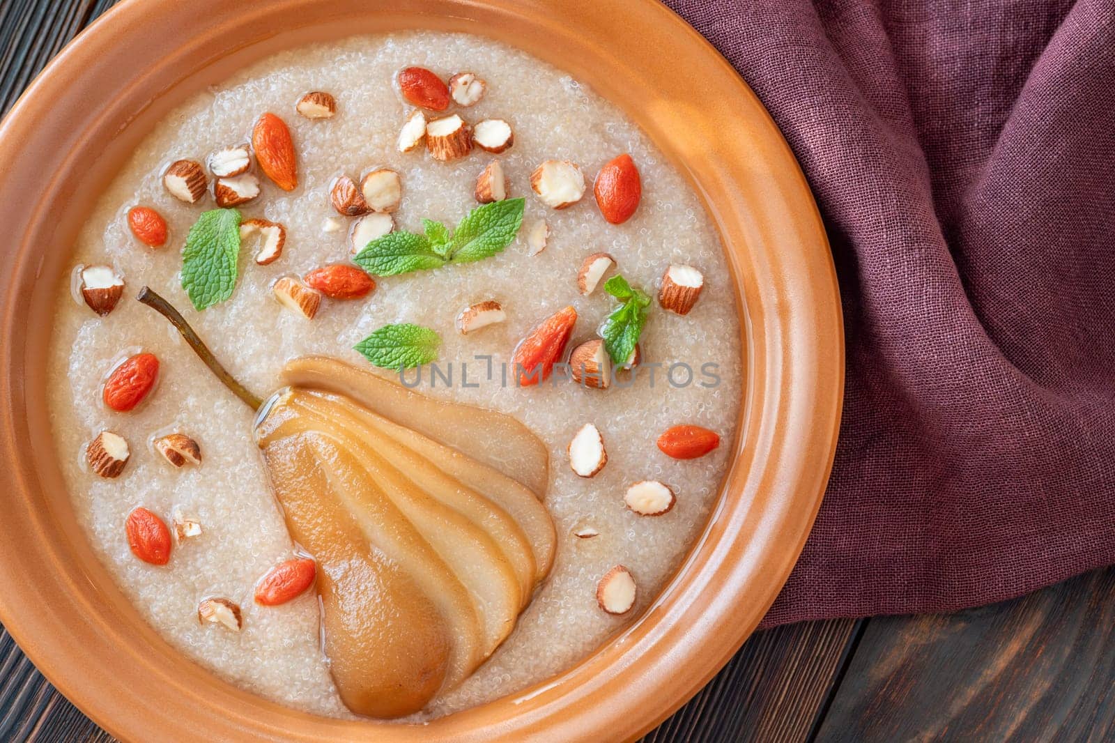 Amaranth Porridge with poached pear, almond and goji