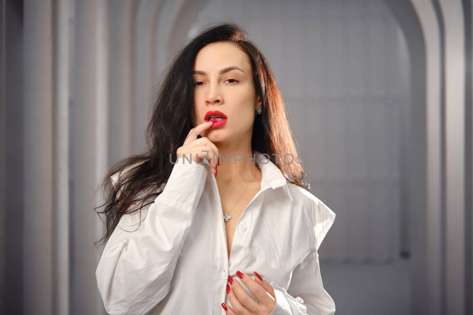 Playful woman biting her fingernail