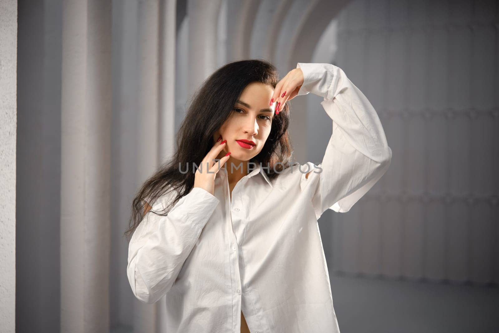 Cute young woman in white cotton shirt waiving her hands