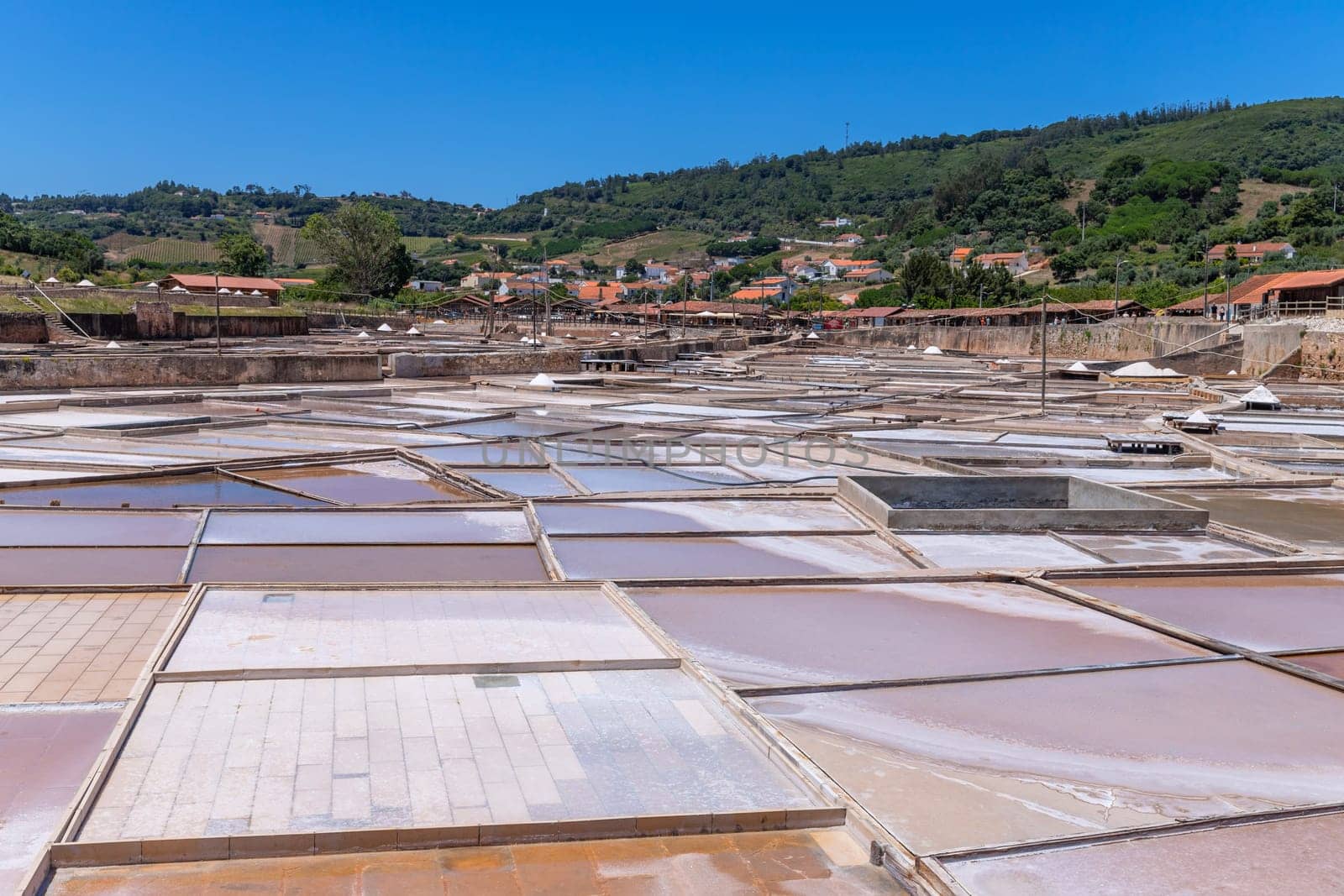 Rio Maior, Portugal: July 7, 2024: Fonte da Bica Salt Flats, aka Salinas de Rio Maior, system of shallow water compartments and gutters for salt extraction, Portugal