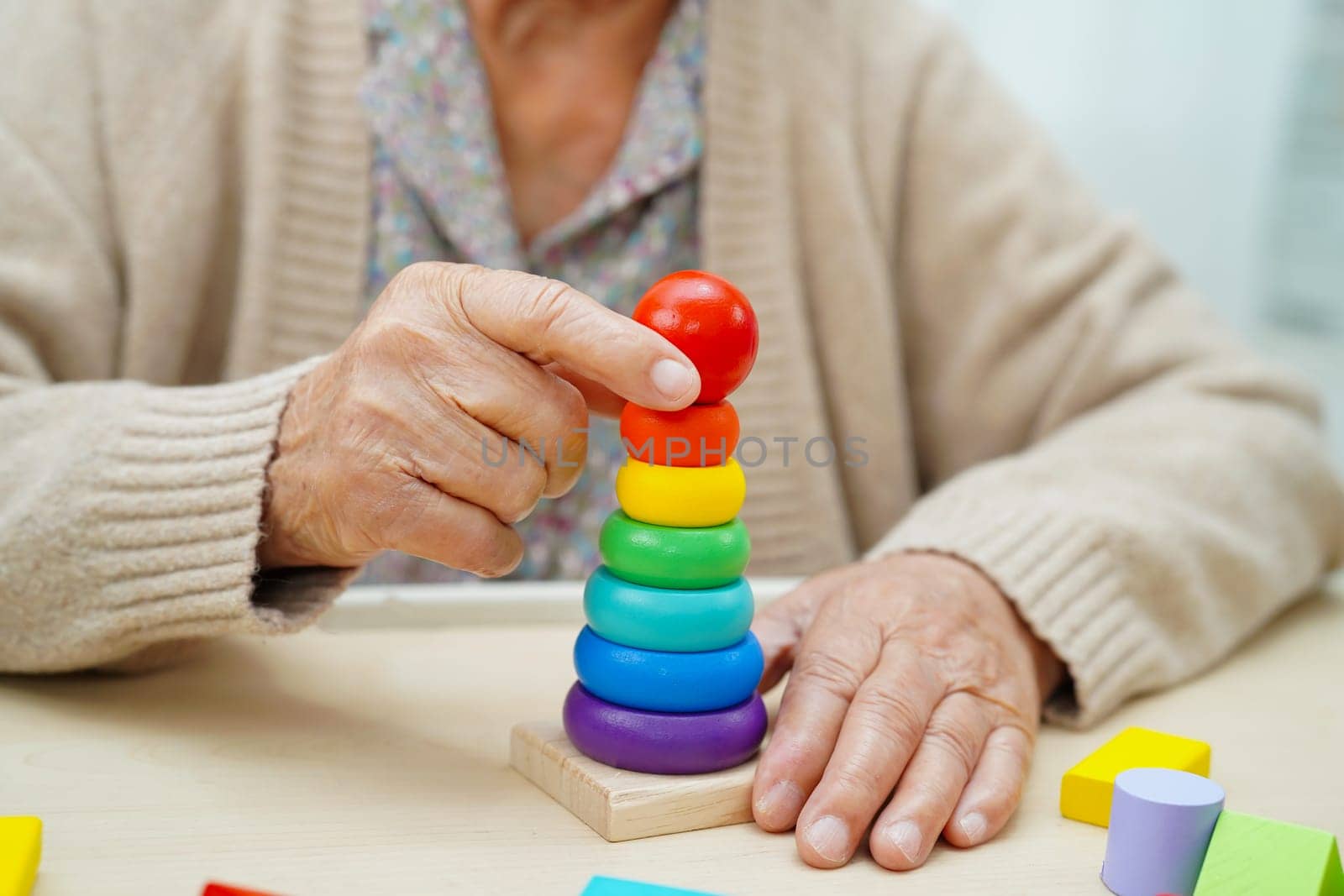 Asian elderly woman playing game.