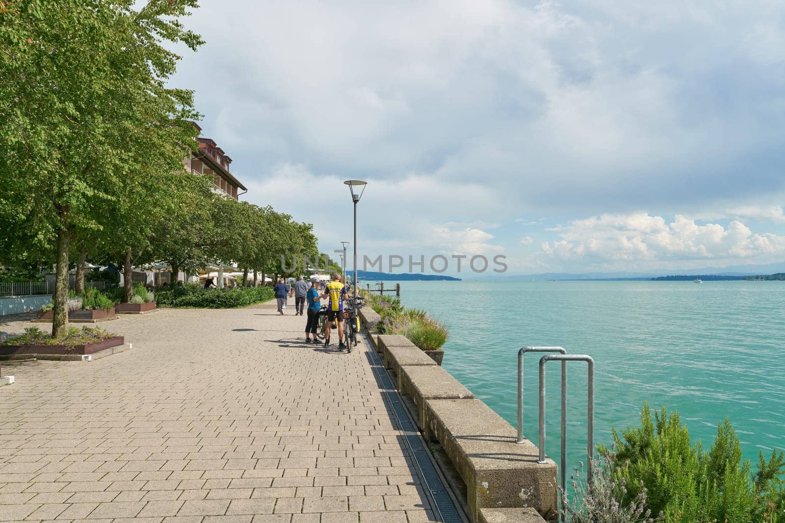 Ueberlingen, Germany – August 02, 2024: Lake promenade, Seepromenade with some tourists in Uberlingen on Lake Constance, Bodensee