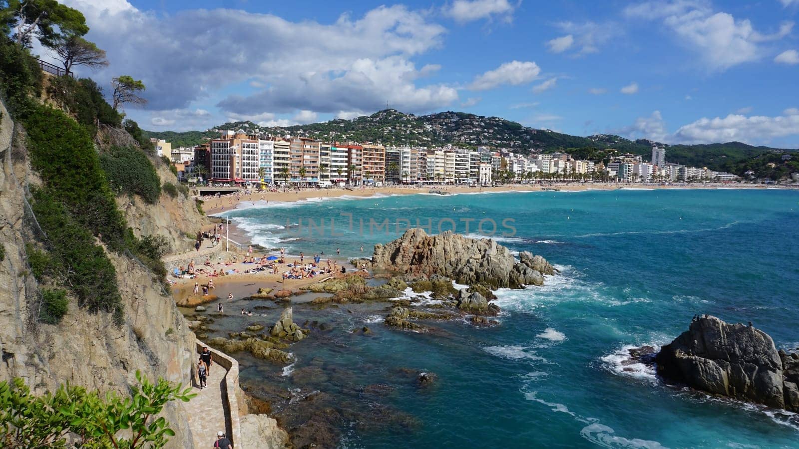 Lloret de mar, Spain - September 30, 2024: People resting at the beach of Lloret De Mar. The beach in Costa Brava of Catalonia at sunny day