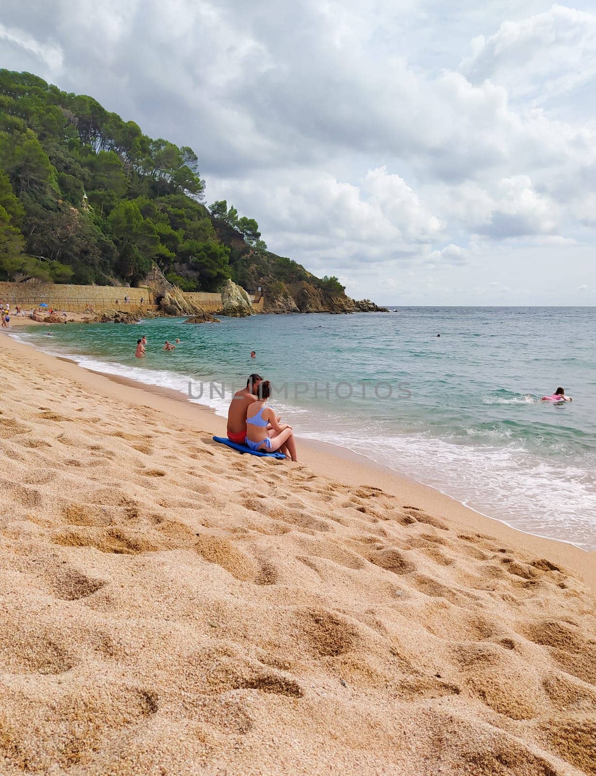 Lloret de mar, Spain - September 30, 2024: People resting at Fenals beach in Lloret de Mar in the Costa Brava, Catalonia, Spain