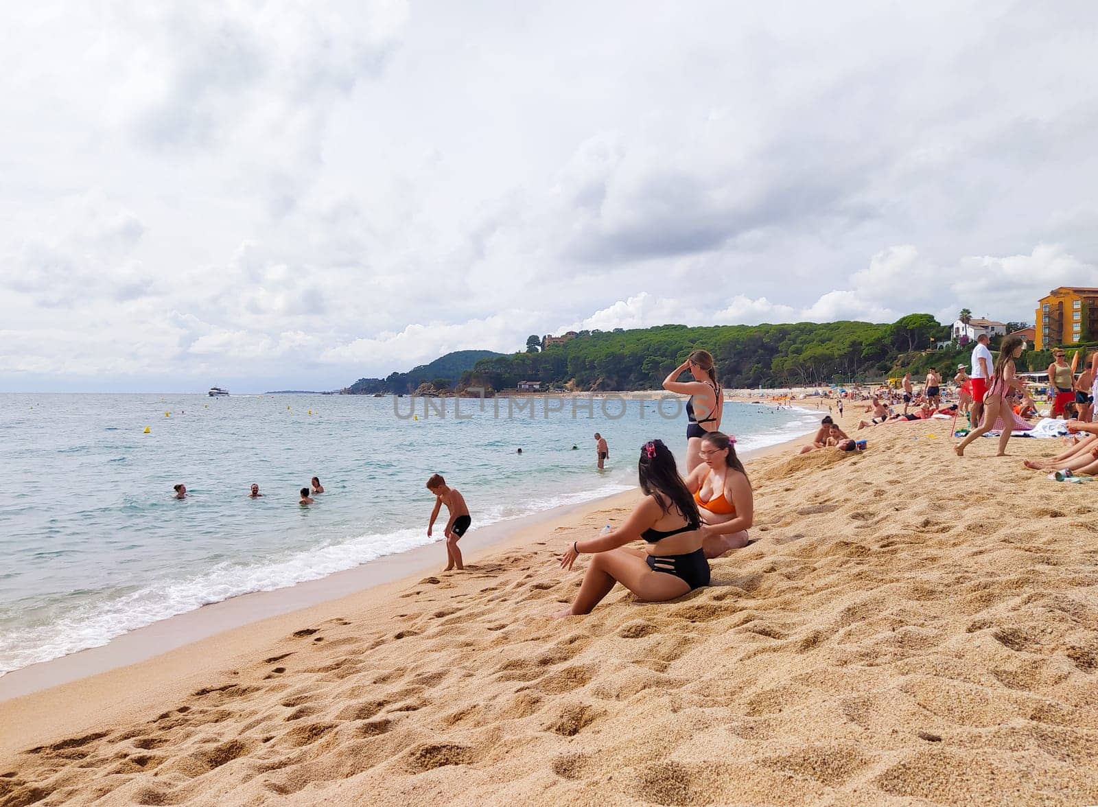 Lloret de mar, Spain - September 30, 2024: People resting at Fenals beach in Lloret de Mar in the Costa Brava, Catalonia, Spain