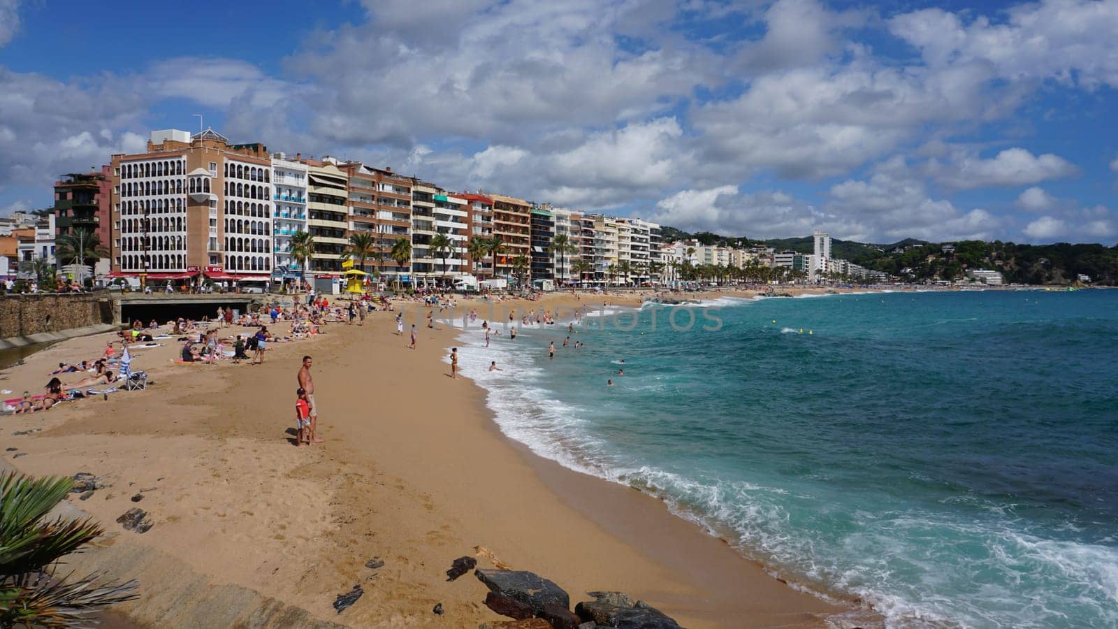 Lloret de mar, Spain - September 30, 2024: People resting at the beach of Lloret De Mar. The beach in Costa Brava of Catalonia at sunny day