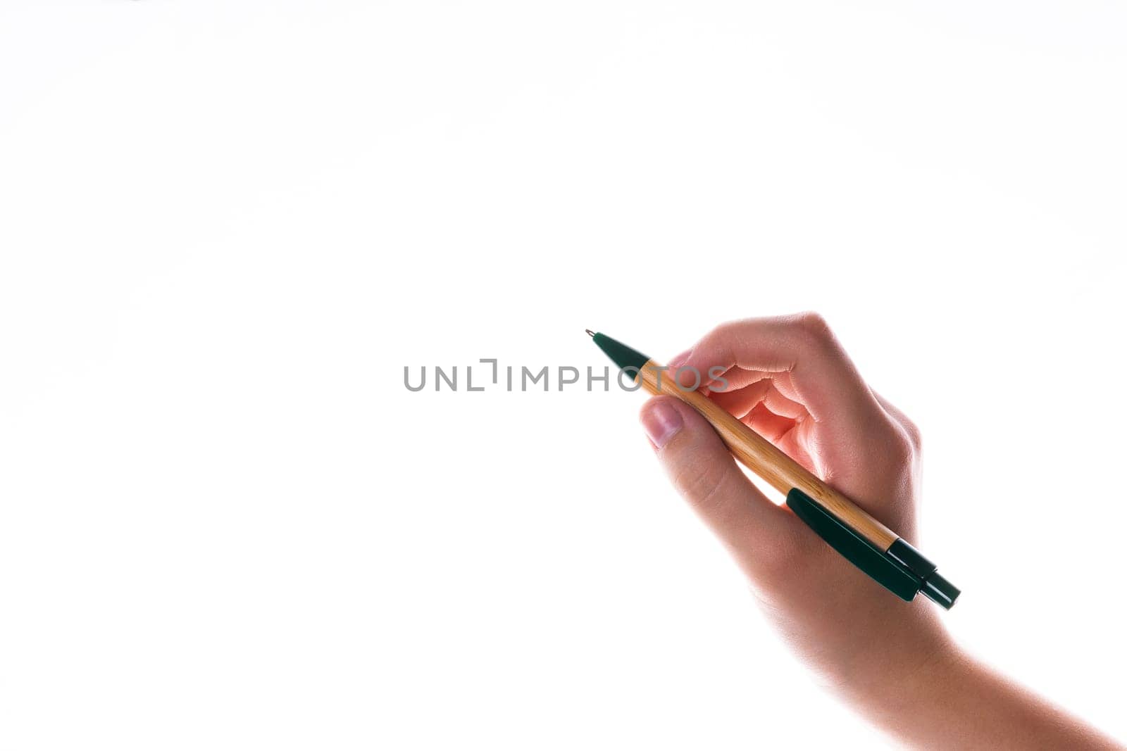 Children hand with pen write on a blue white background. Writing hand.