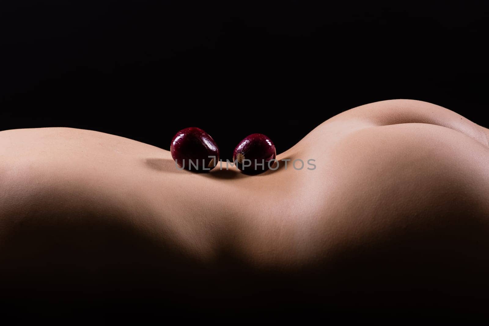 Close up of a woman back with laying onion, low key