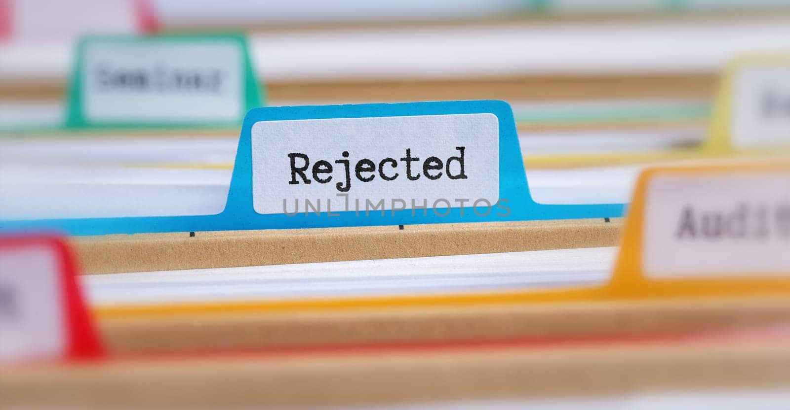 File folders with a tab labeled Rejected