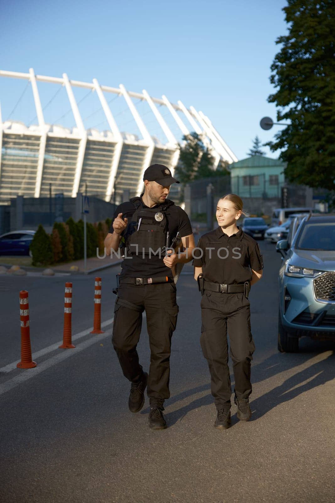 Friendly smiling patrol police officers on the street during the watch