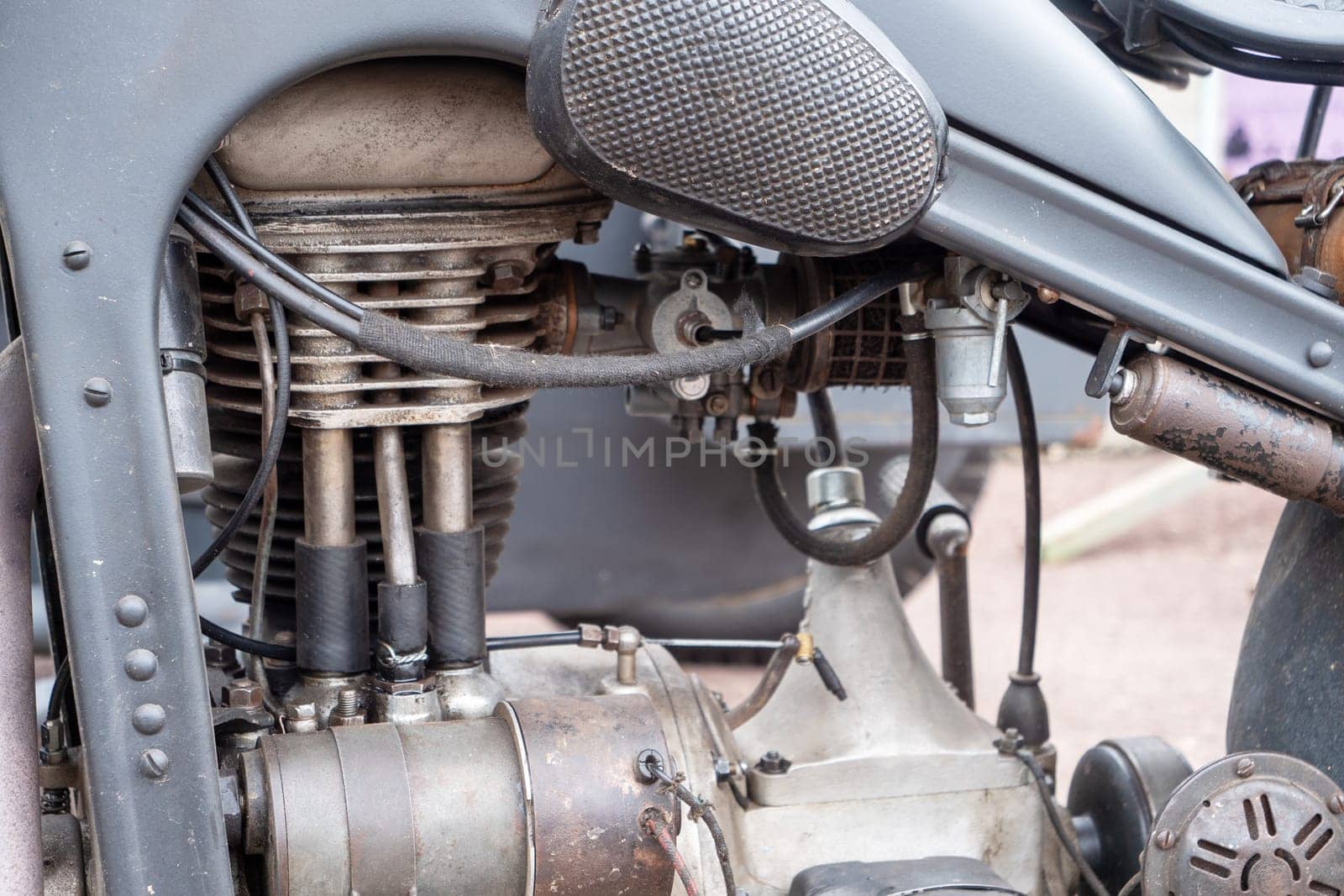 A motorcycle engine is old and rusty