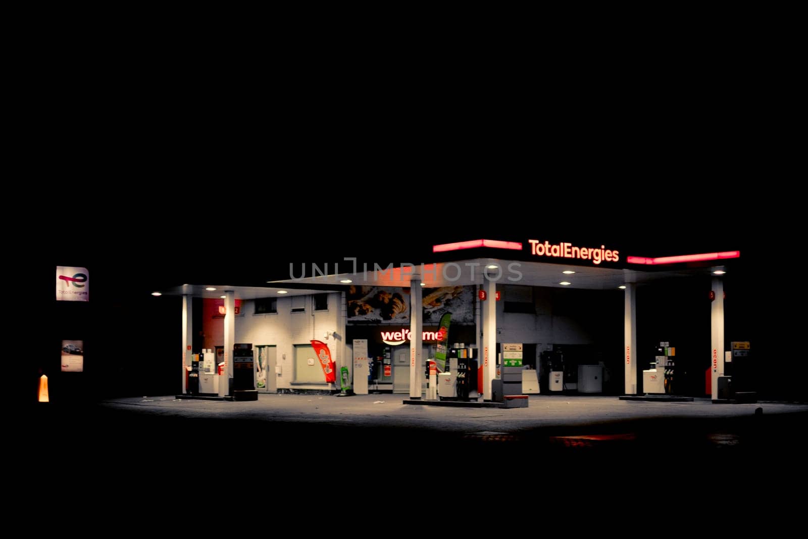 Sint-Niklaas, Belgium, October 6th 2024: Night view on illuminated Total Energies gas station in Belgium