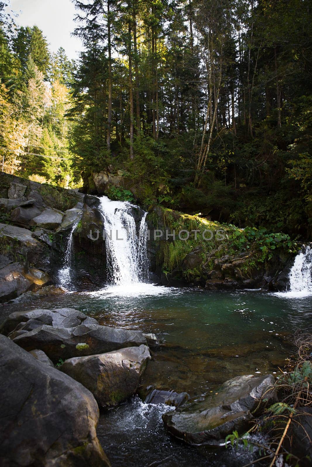 Very beautiful waterfall in autumn in the forest. Ukraine, Carpathians.