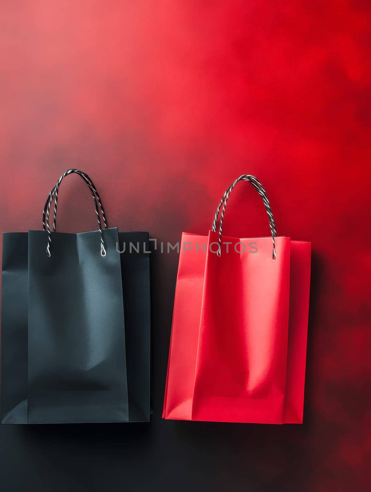 Black and red shopping bags on a striking gradient background with ample copy space for text. Black Friday sale concept with empty place for text.