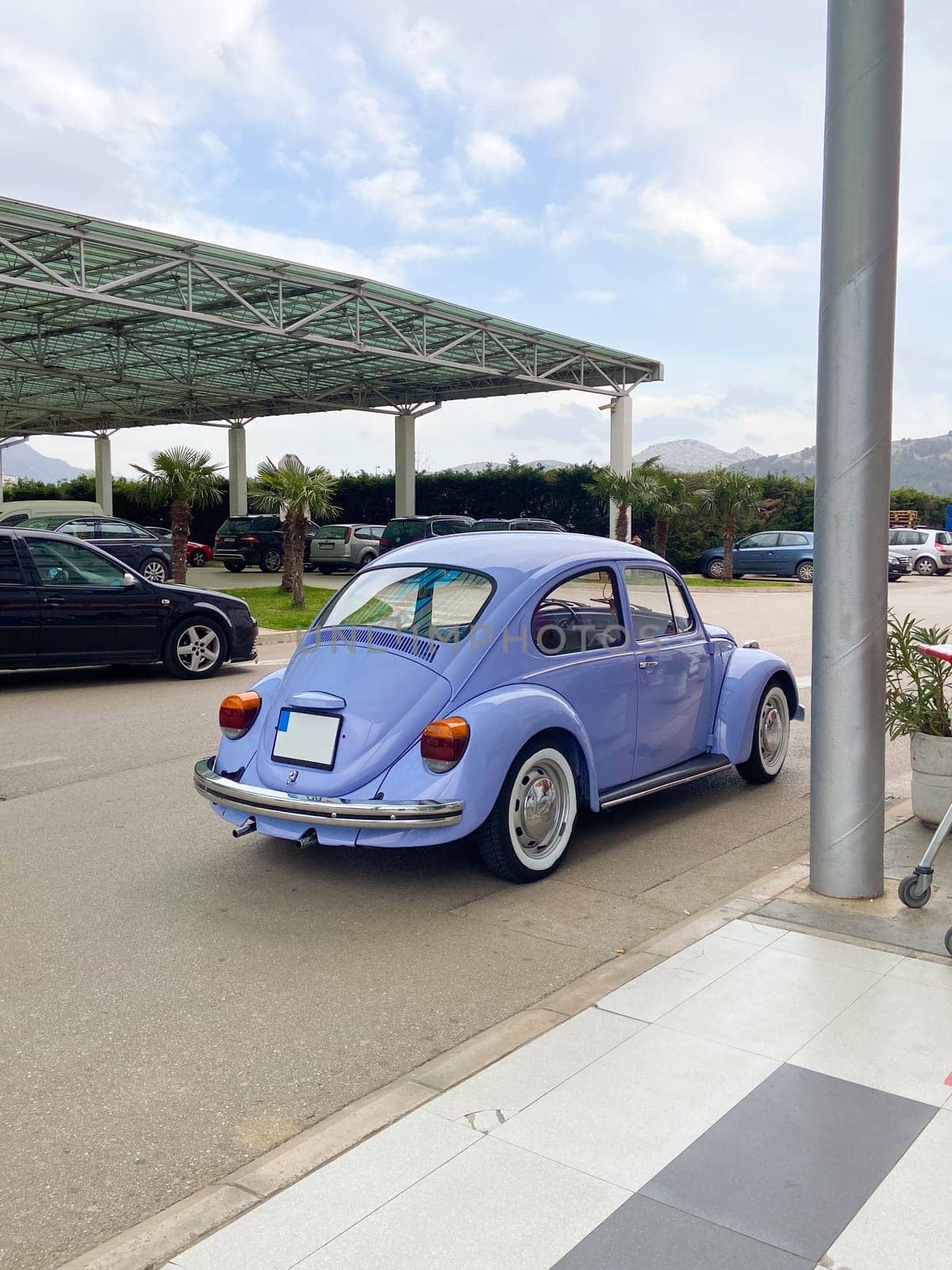 Vintage violet car on the street in summer. Old-fashioned nostalgia and retro style concept.