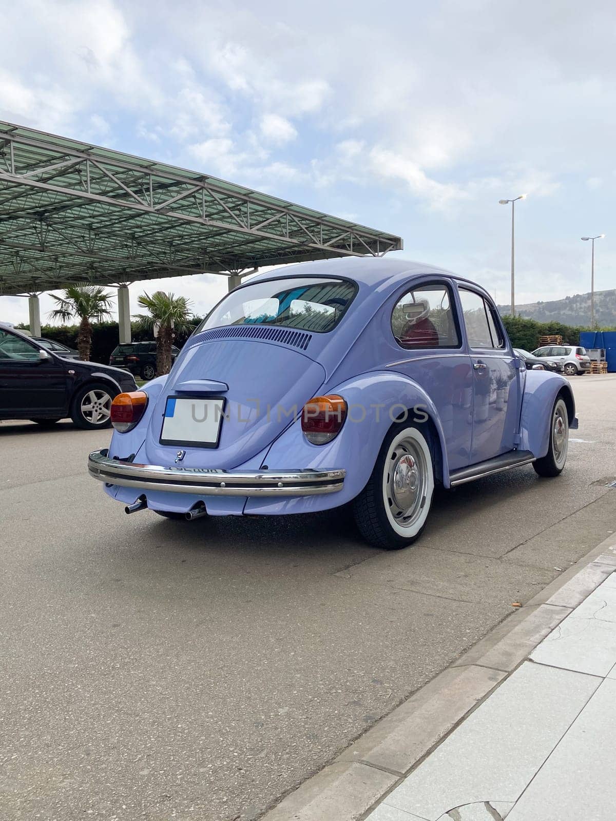 Vintage violet car on the street in summer. Old-fashioned nostalgia and retro style concept.