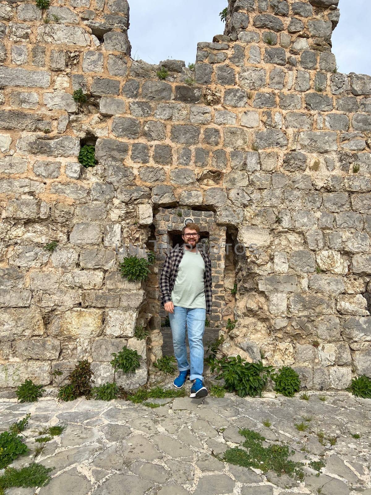 Man walking on ruins of fortress in Stary Grad , Bar, Montenegro.