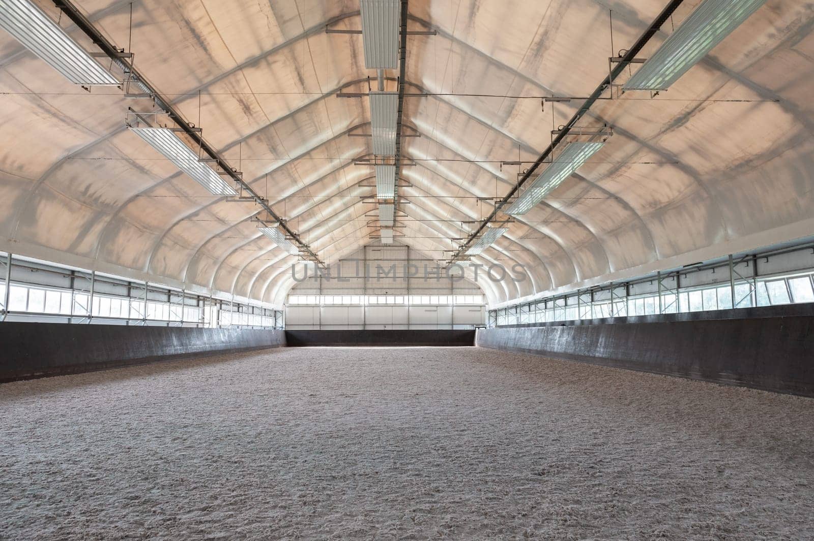Empty horse riding arena indoor without people
