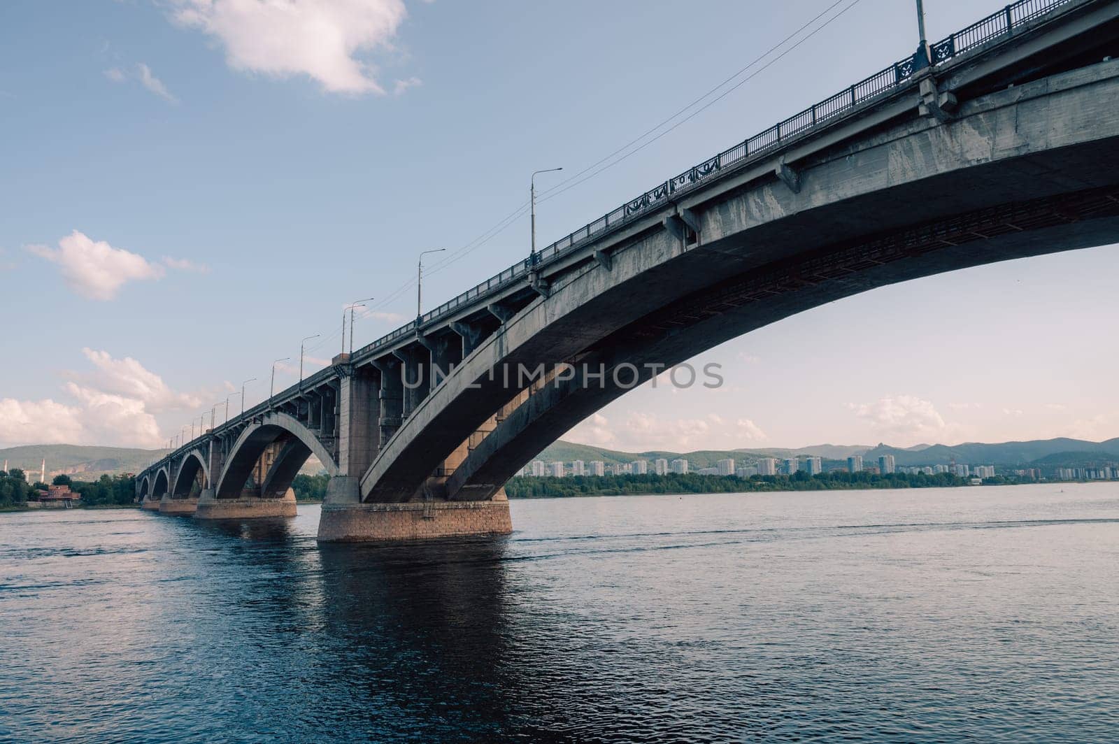 Communal bridge over the Yenisei River at beauty sunny summer day in Krasnoyarsk city.