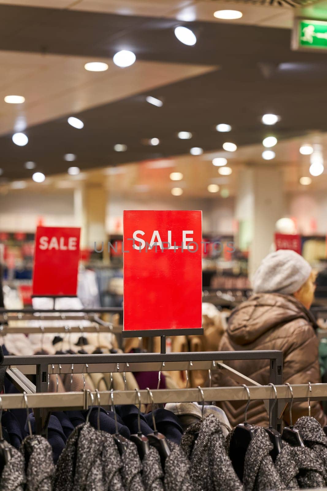 Sign with the inscription Sale to indicate a special offer in a clothing store