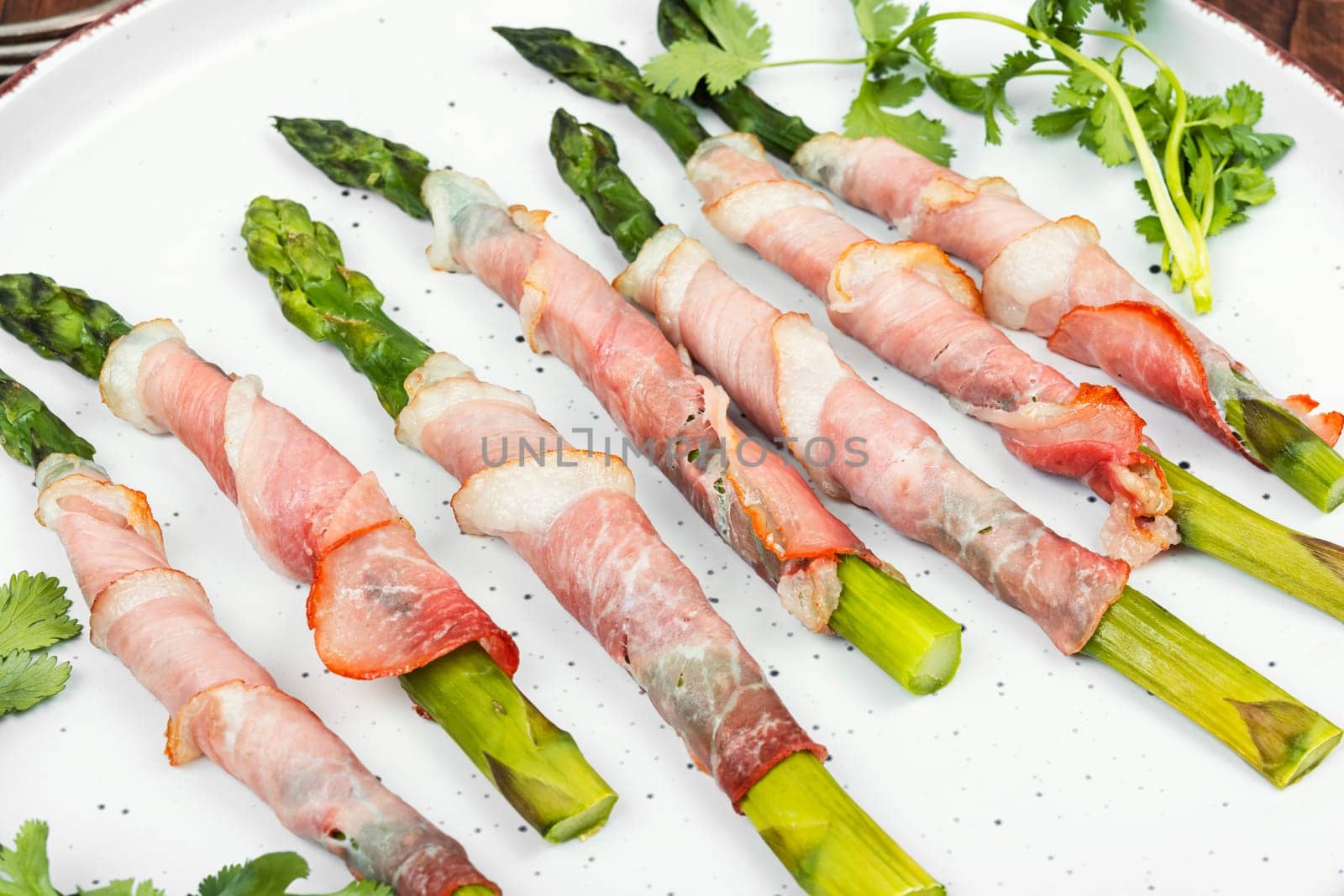 Young green asparagus baked in bacon. Top view.