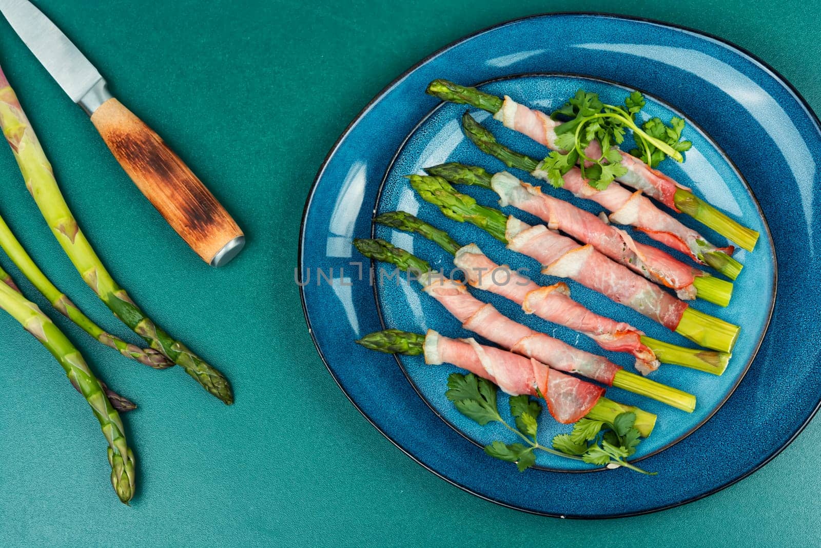 Young green asparagus baked in bacon. Top view.