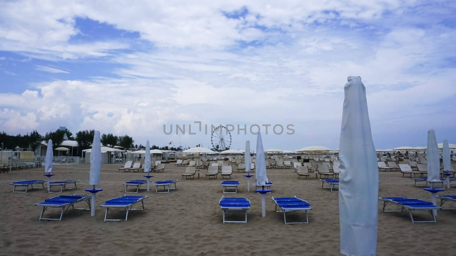 Summer. The sunbeds and parasols on the empty beach