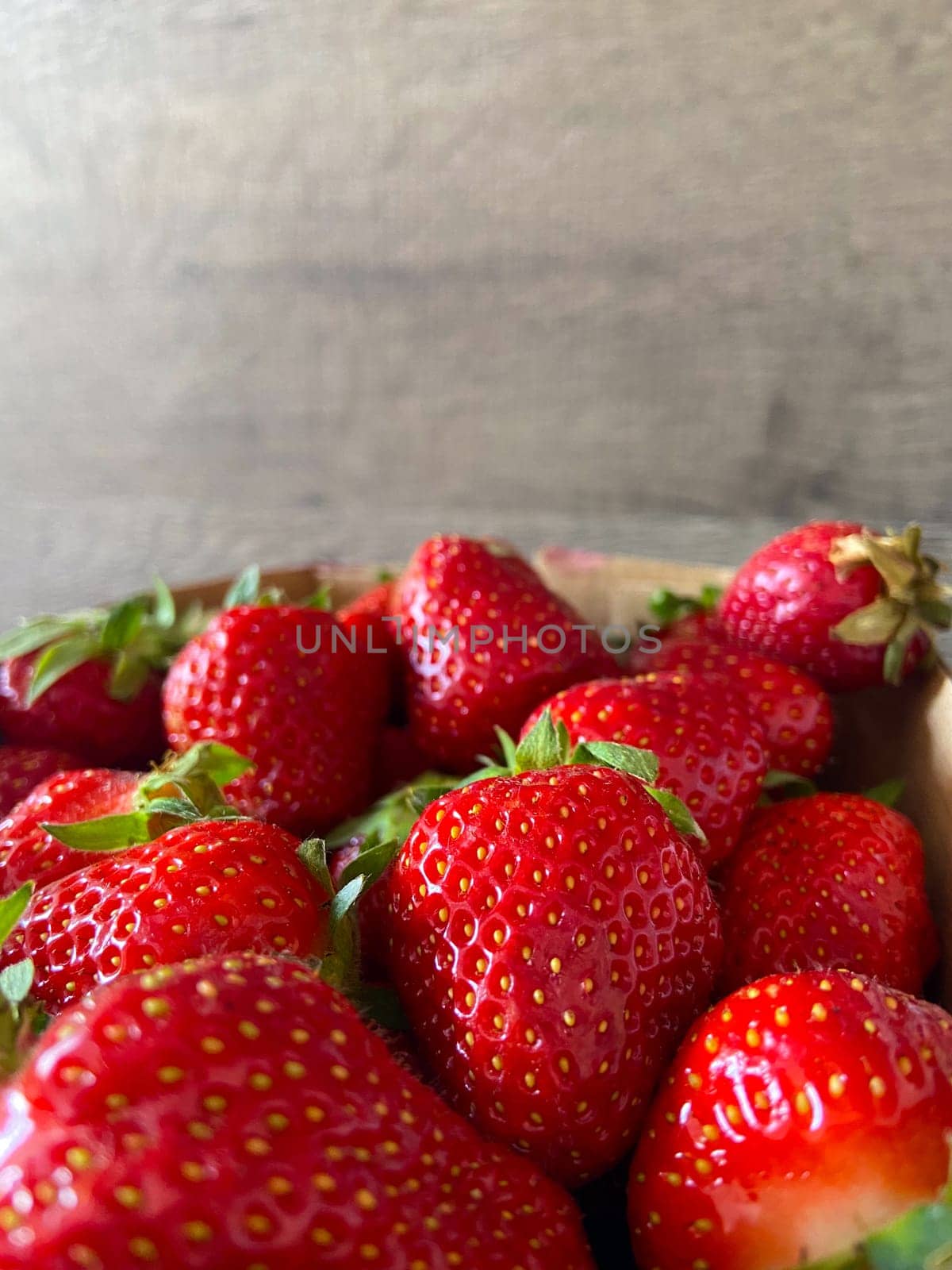 Vibrant collection of fresh strawberries fills the frame, showcasing their bright red hue and inviting texture. Close-up captures the essence of natural sweetness and summer abundance.