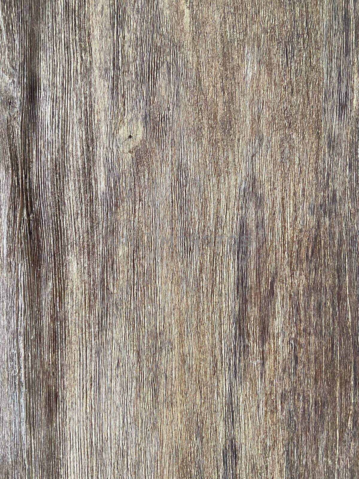 Rustic wooden panel leans gracefully against a textured, showcasing its rich grain patterns and natural warmth.