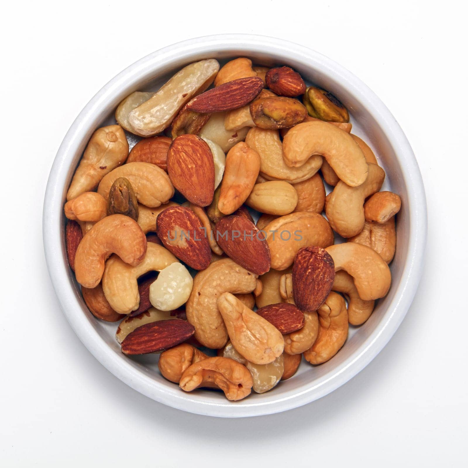 Mixed nuts in round container isolated on a white background