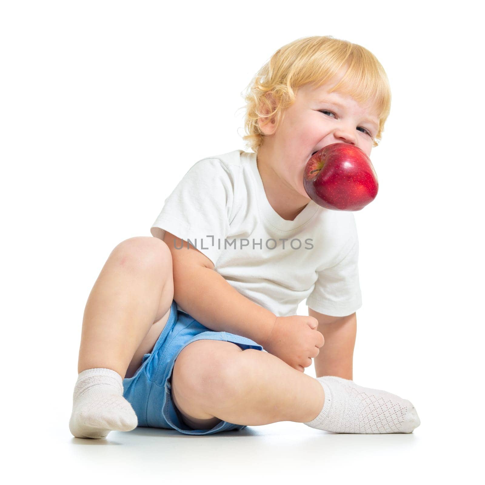 kid holding apple in mouth