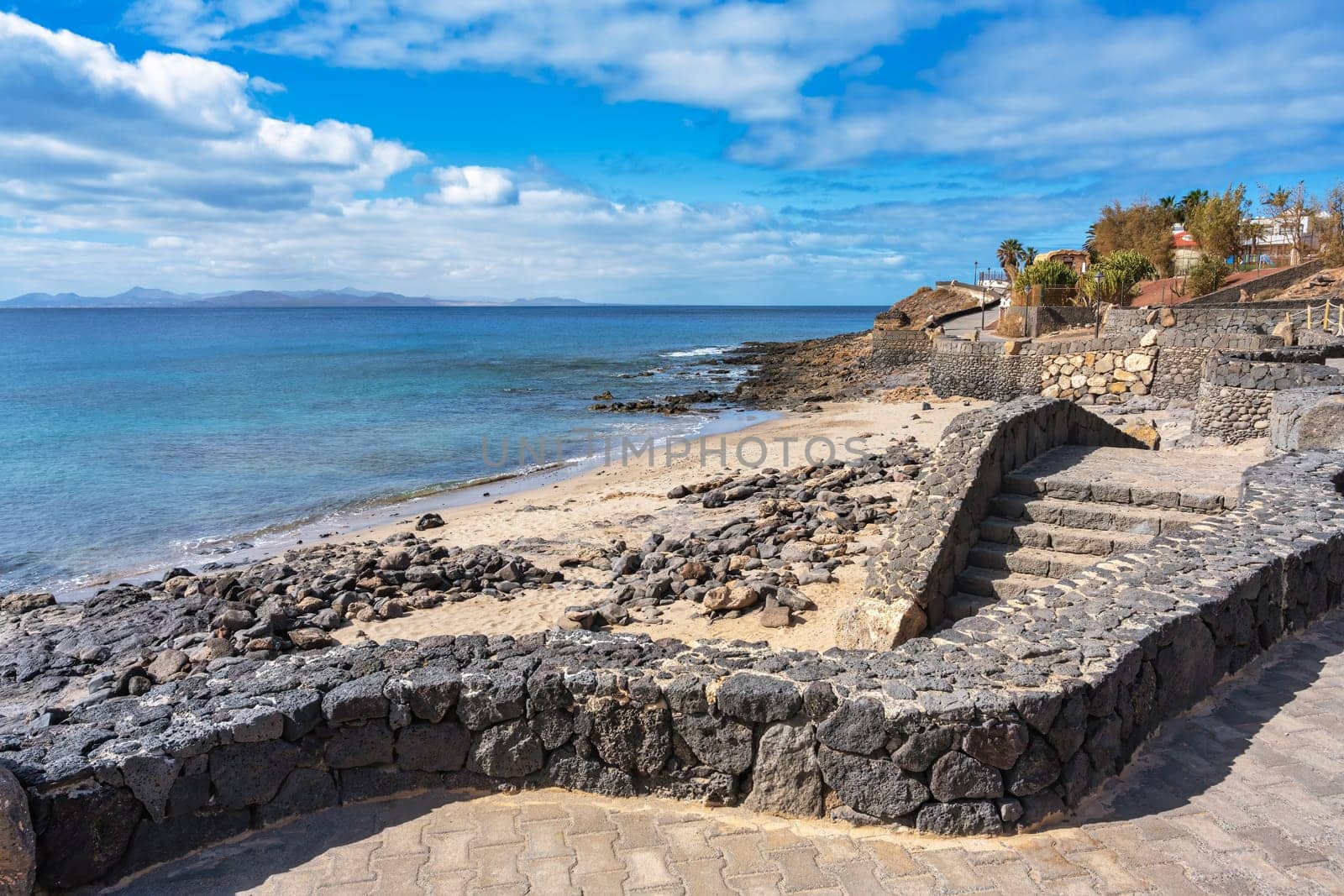 Steps from the promenade down to the beach at Playa Blanca with a view of the Atlantic Ocean on Lanzarote