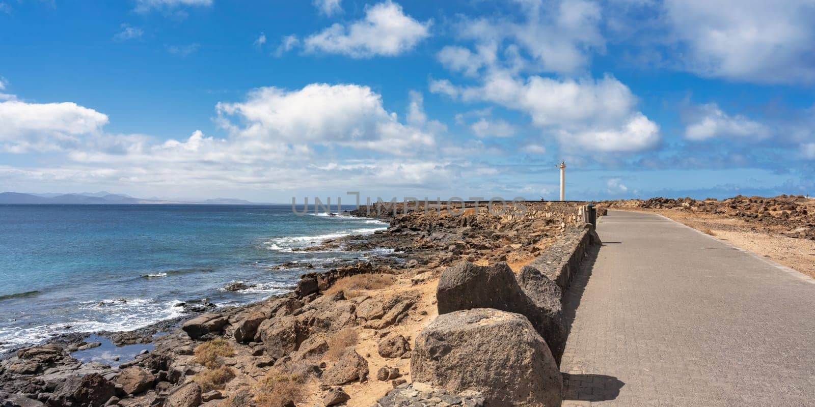 Coast along the promenade to the Faro de Punta Pechiguera lighthouse at Playa Blanca on Lanzarote