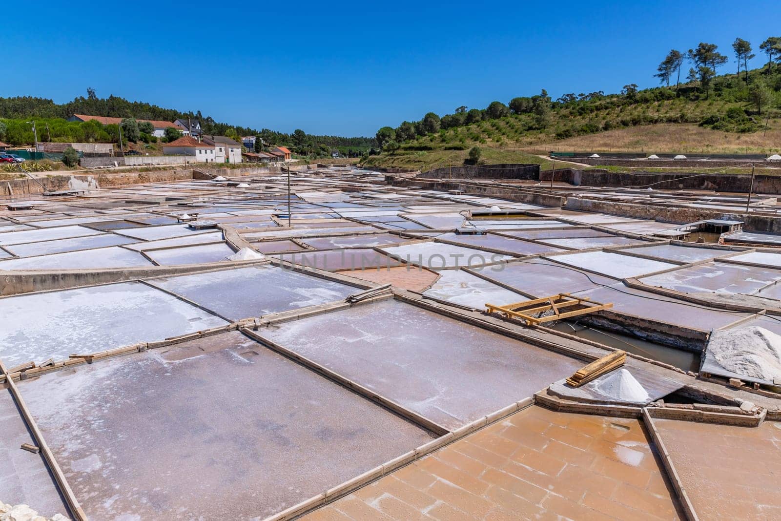 Rio Maior, Portugal: July 7, 2024: Fonte da Bica Salt Flats, aka Salinas de Rio Maior, system of shallow water compartments and gutters for salt extraction, Portugal