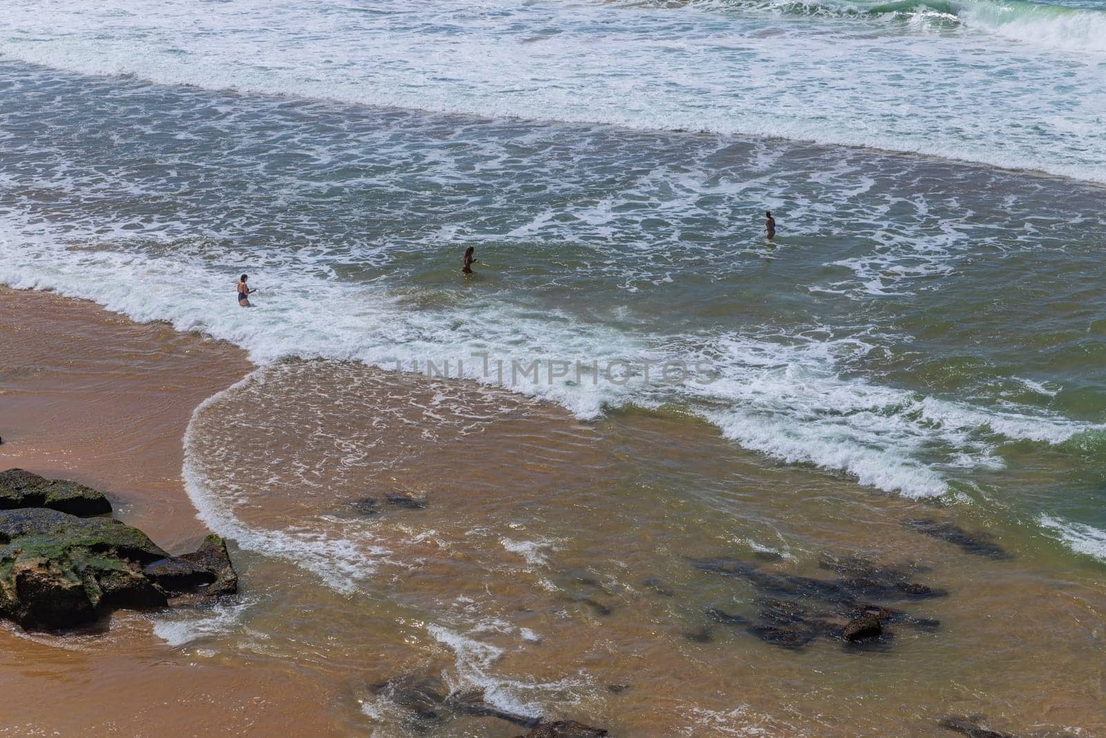 Sintra, Portugal: April 13, 2024: People at the beach of Ericeira, Mafra, Portugal