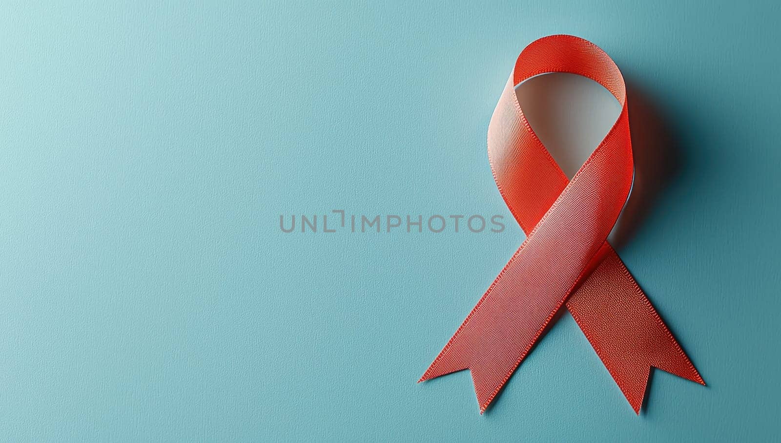 Red awareness ribbon on teal background, symbol for HIV/AIDS support and solidarity