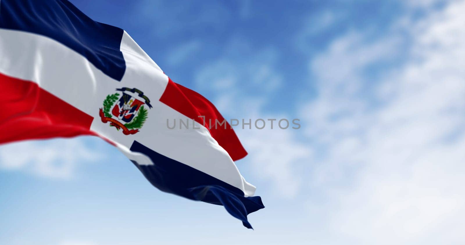 Detail of the national flag of the Dominican Republic waving in the wind on a clear day. Democracy and politics. 3d illustration render. Selective focus. Fluttering fabric