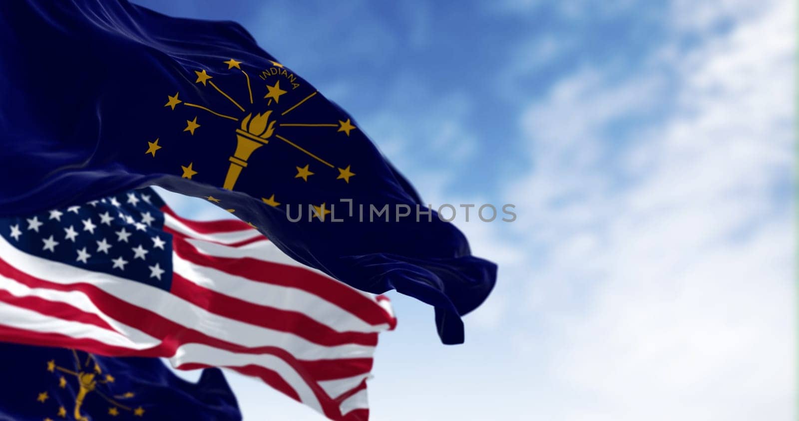 Indiana state flags waving with the national flag of the United states on a clear day. 3d illustration render. Selective focus. Fluttering fabric