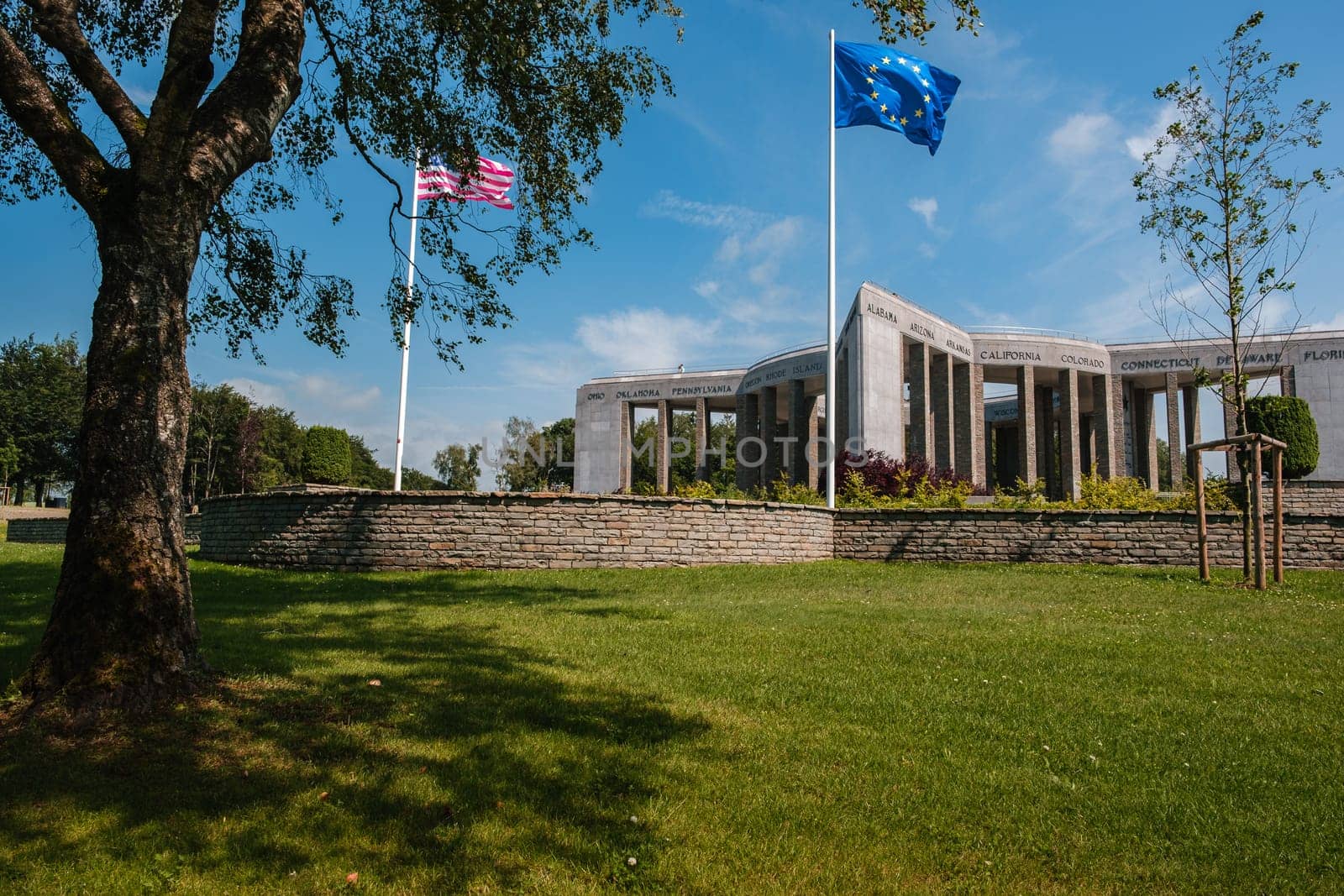 Bastogne, Luxembourg, Belgium - JULY 17, 2021: Mardasson Mermorial remembering Battle of the Bulge. American & EU flags in the foreground