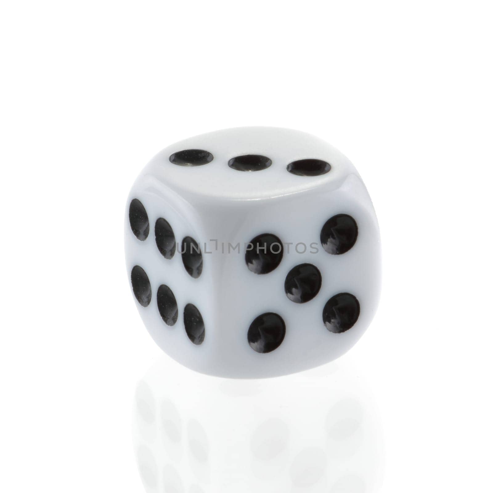 A single white dice isolated on white with front reflection