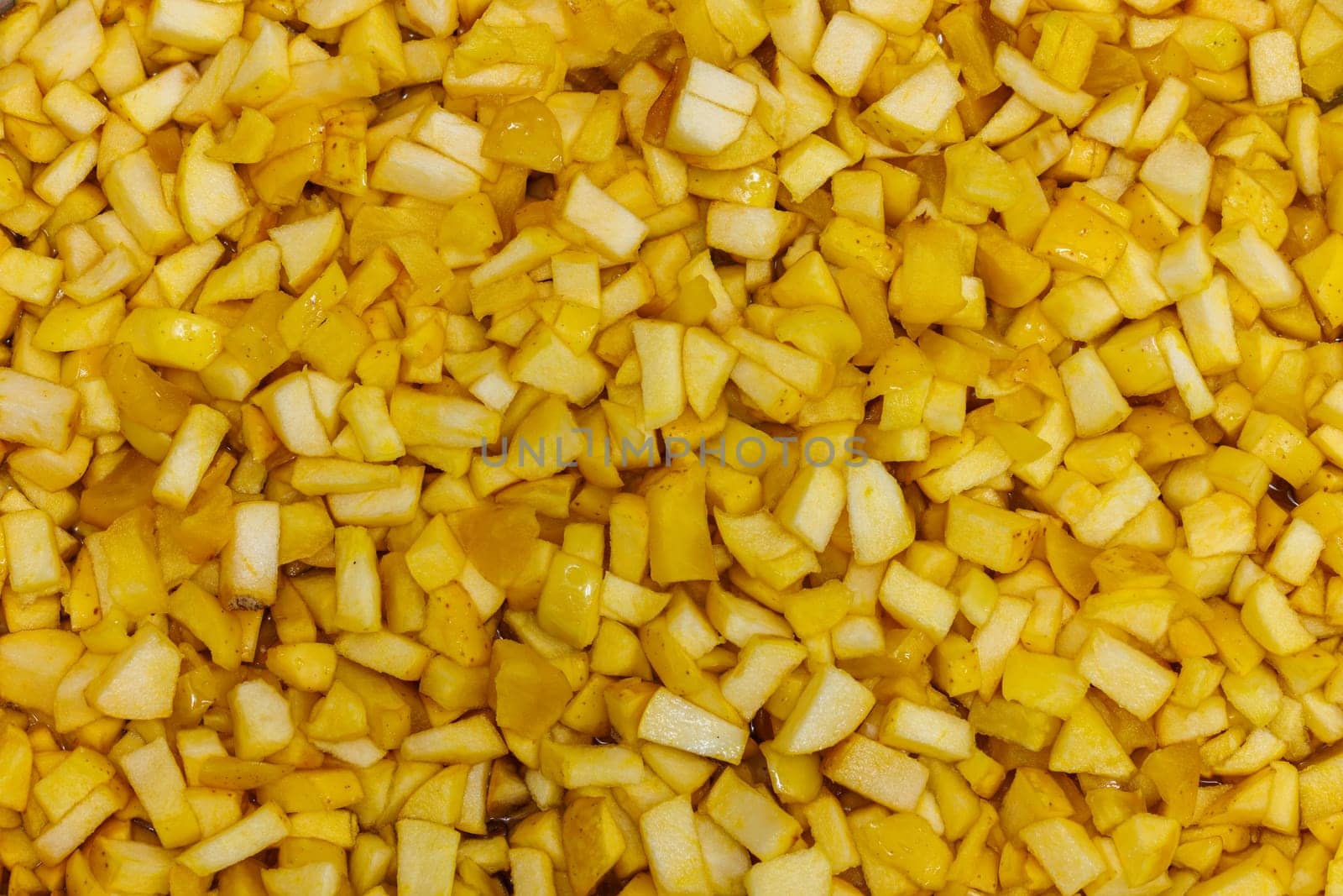 full-frame background and texture of many yellow apples sliced in order to make an apple jam