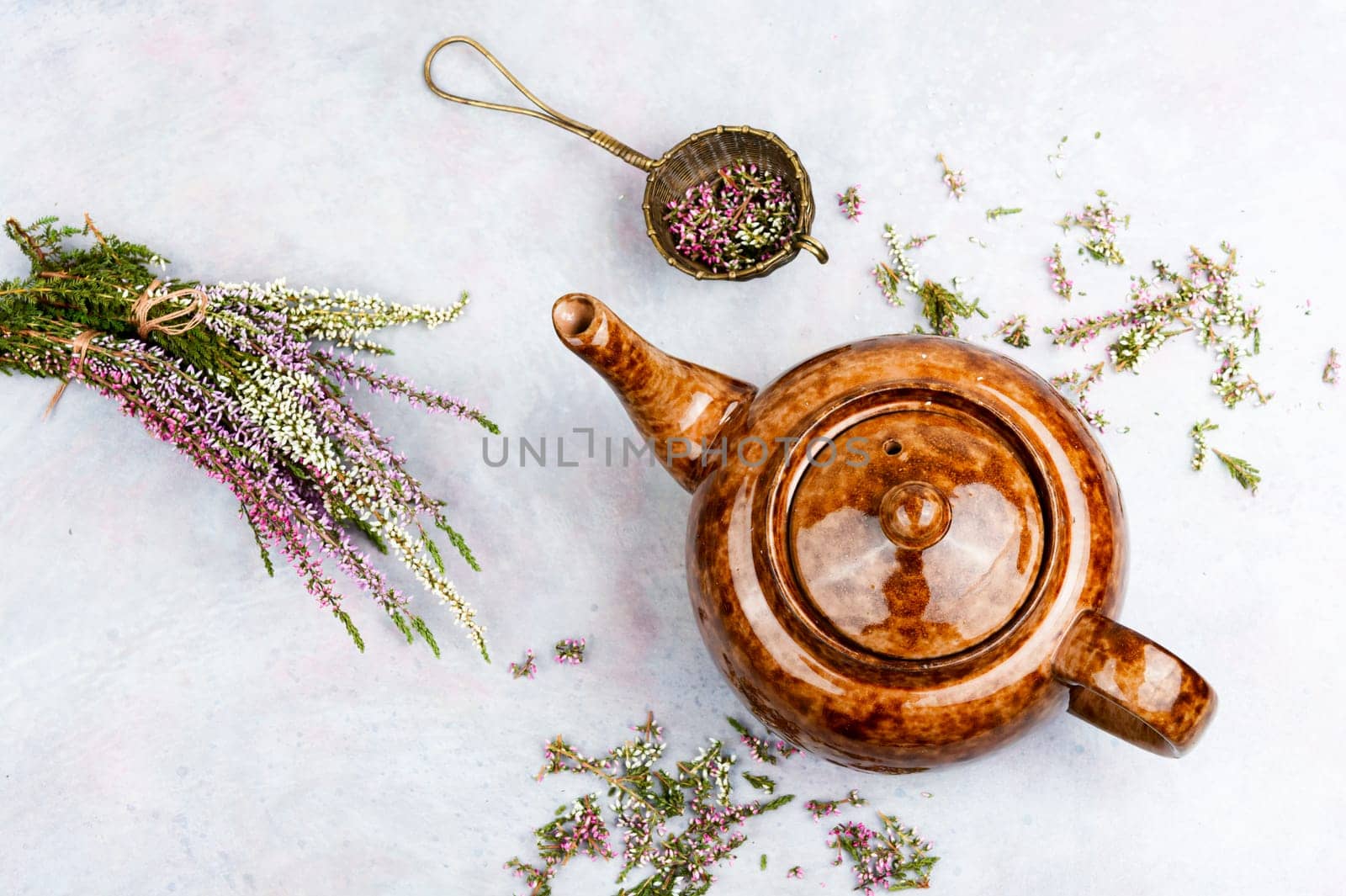Heather herbal tea in a glass mug and forest herbs on a table. Tea from autumn herbs. Phytotea.