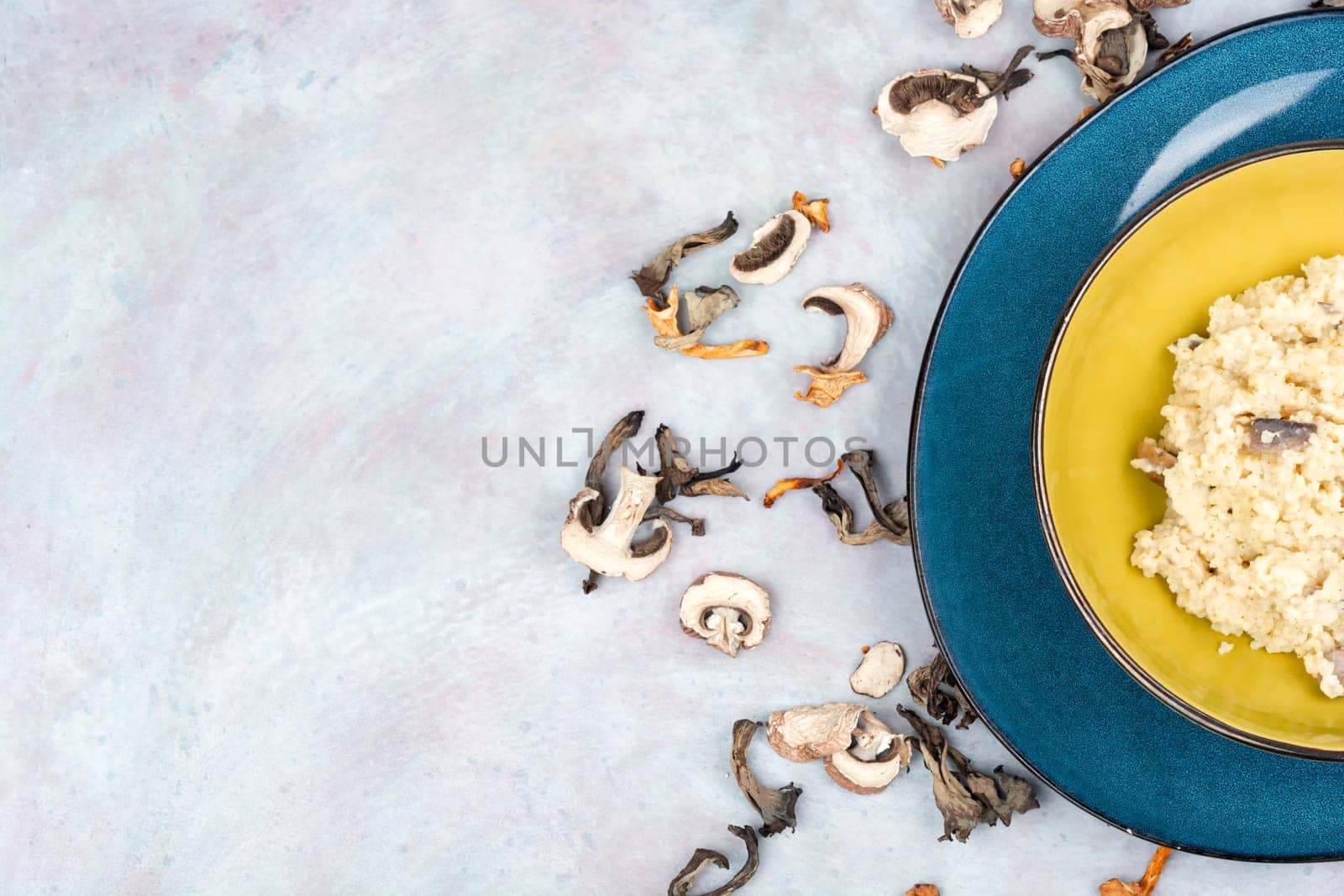 Yellow millet grain porridge with mushrooms. Vegan healthy food. Copy space.