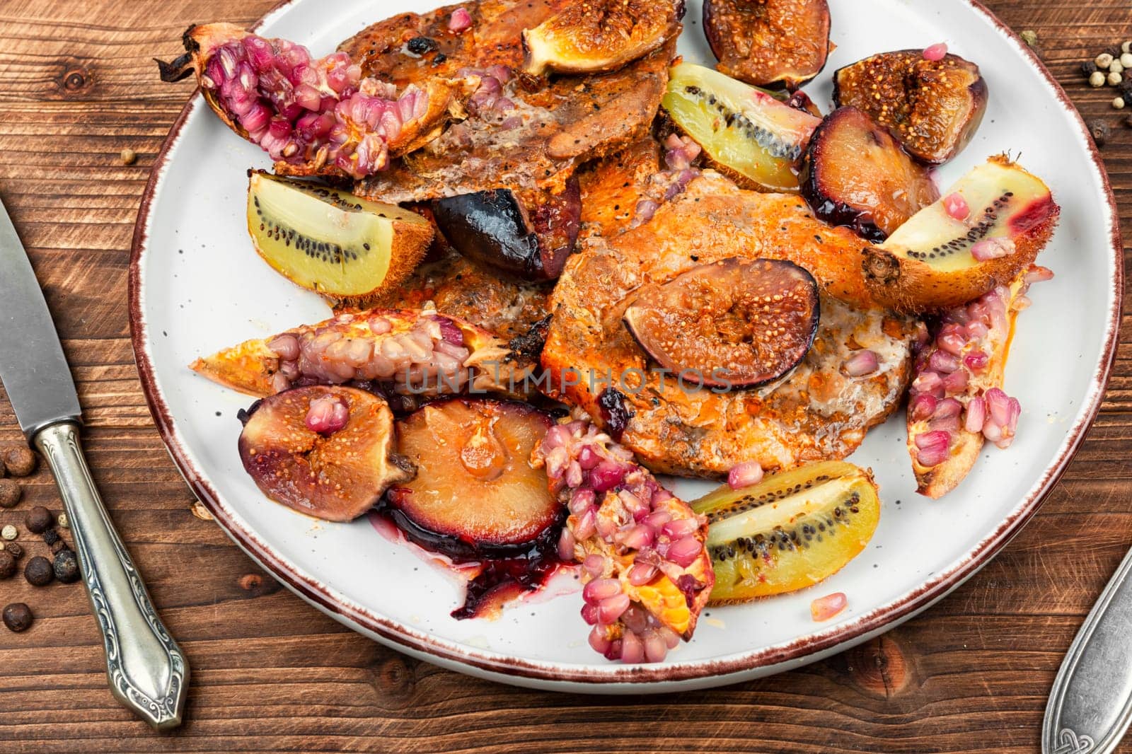 Roasted pork chop with seasonal fruit. BBQ pork chops. Meat barbecue. Close up.