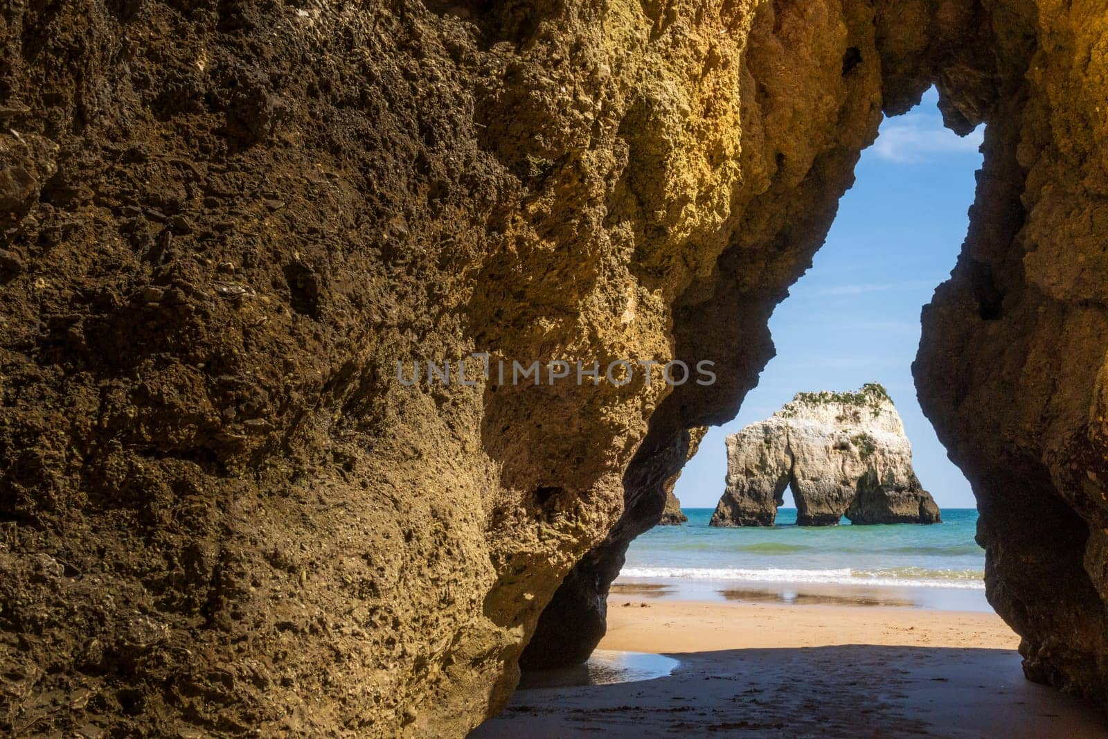 Beach photographed through the rock cut, near Portimão in the Algarve region of Portugal