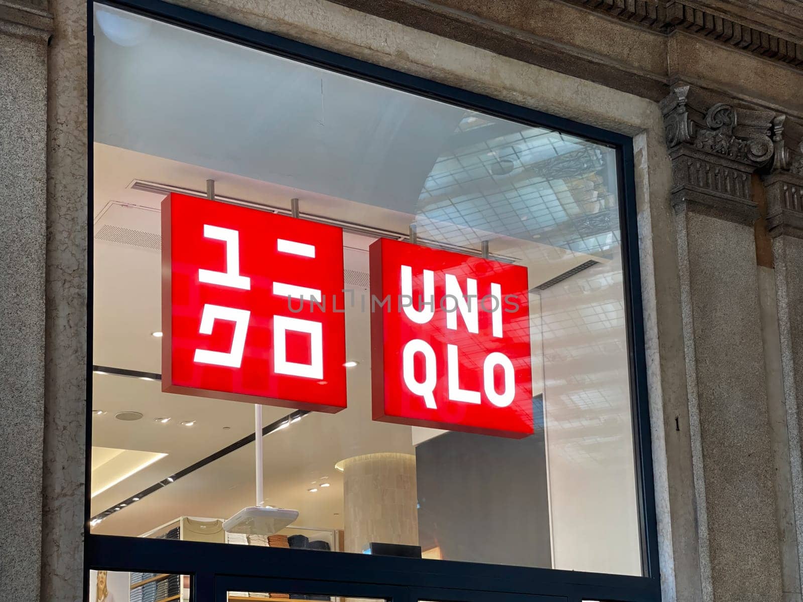 Rome, IT, Oct. 11 2024  Illuminated Uniqlo store sign displayed in a shop window in Galleria Alberto Sordi in Rome. Uniqlo is a popular Japanese clothing brand with global presence.