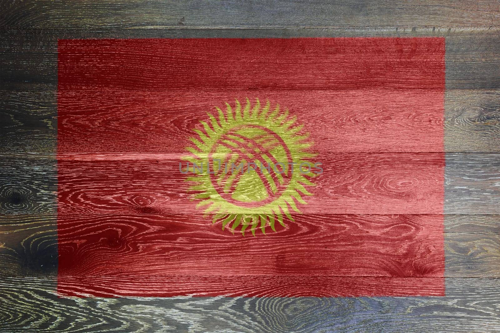 A Kyrgyzstan flag on rustic old wood surface background