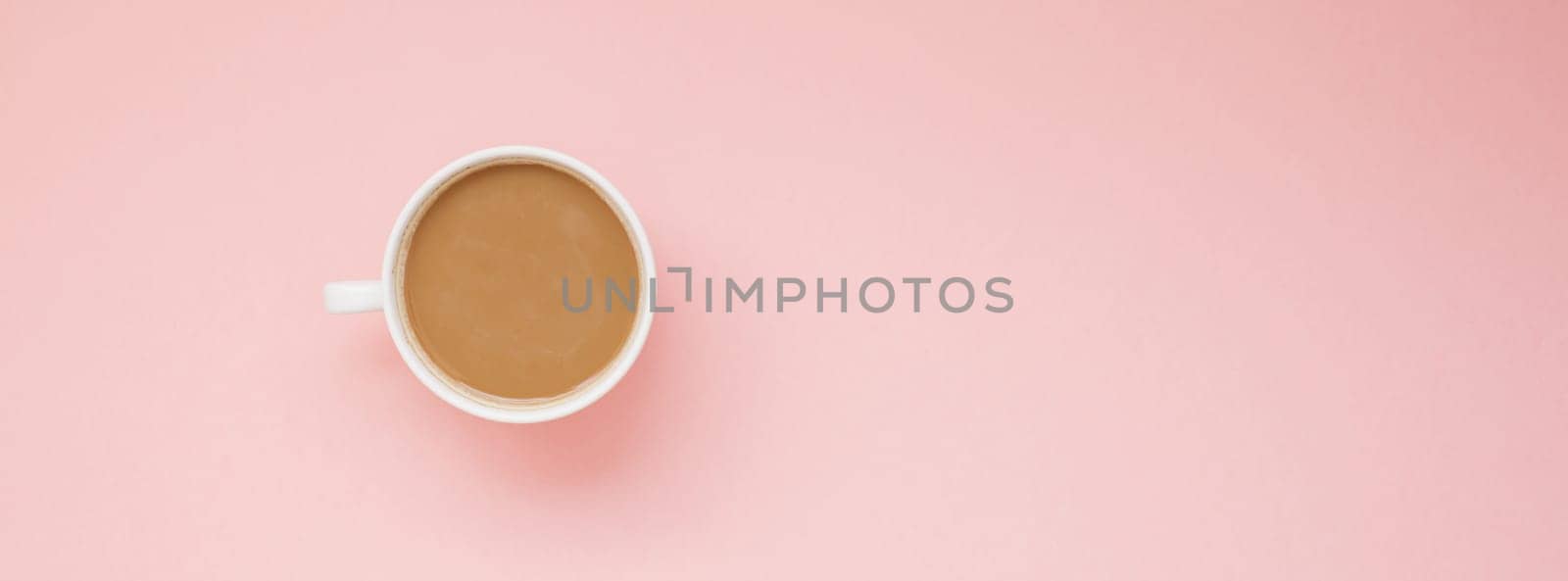 Creative autumn flat lay overhead top view coffee milk latte cup on millennial pink background copy space minimal style. Fall season template for feminine blog social media Long wide banner